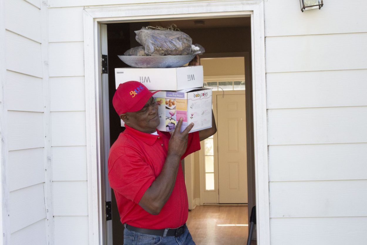 5 star team member carrying unwanted junk out of home