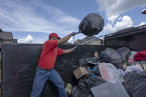 5 star Junk removal worker loading the truck